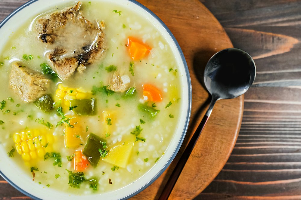 Stock photo of a bowl of soup with corn and potatoes